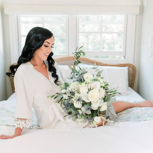 Bride wearing Ella satin bridal robe with lace detail during wedding morning preparation by Missosca