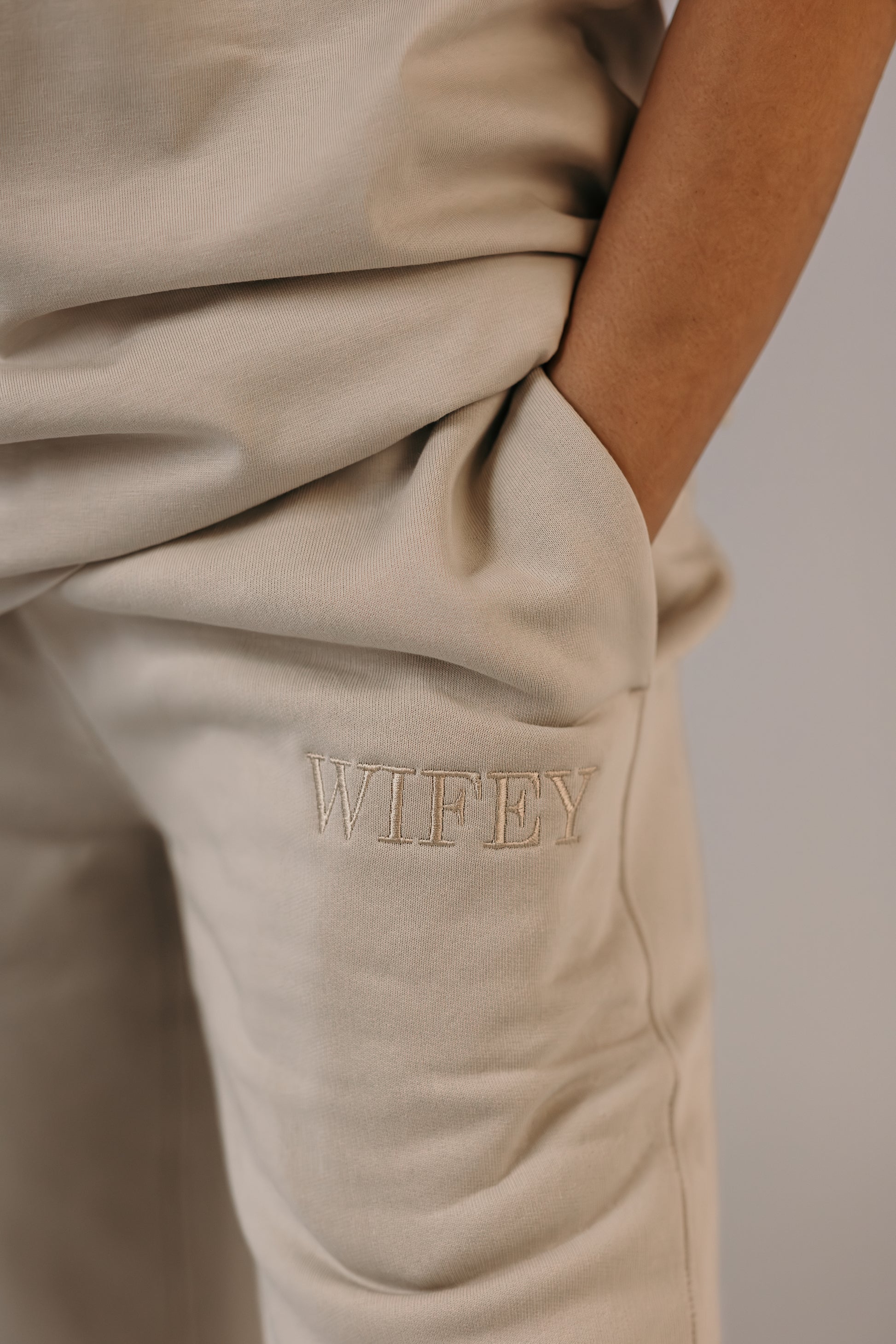 Bride wearing wifey track pants bone colour champagne embroidery Missosca Australia