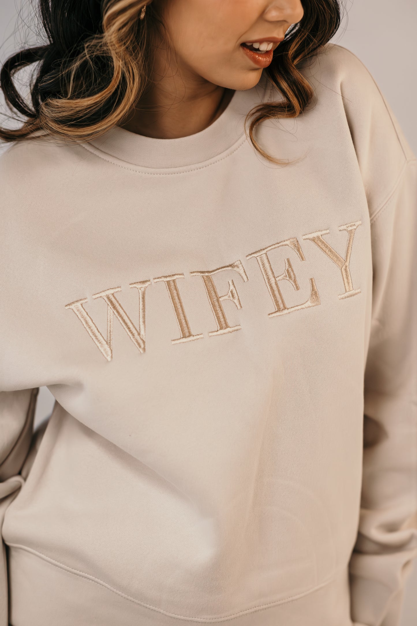 Wifey crew sweater close up champagne embroidery detail