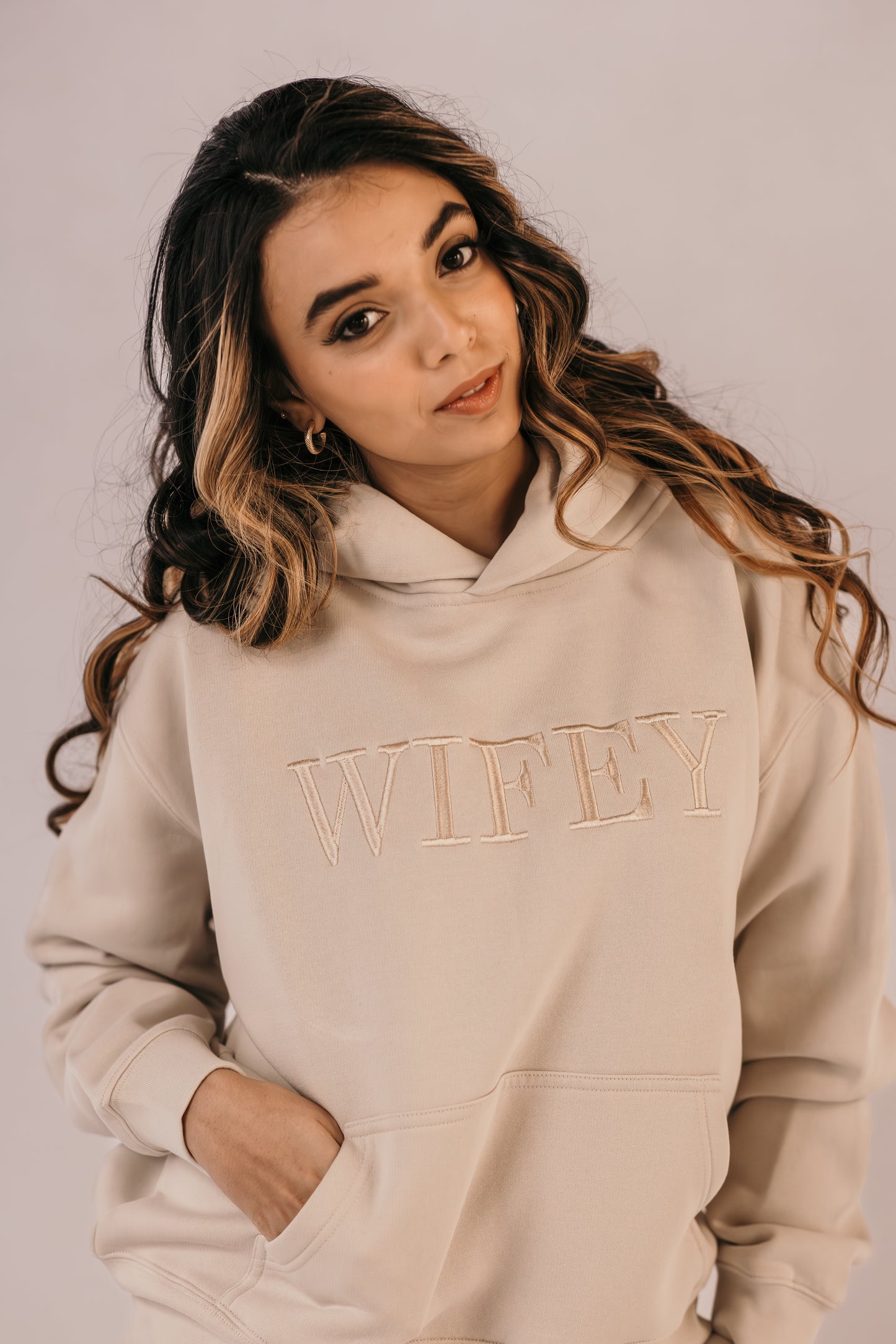Bride wearing bone wifey hoodie with champagne embroidery Missosca