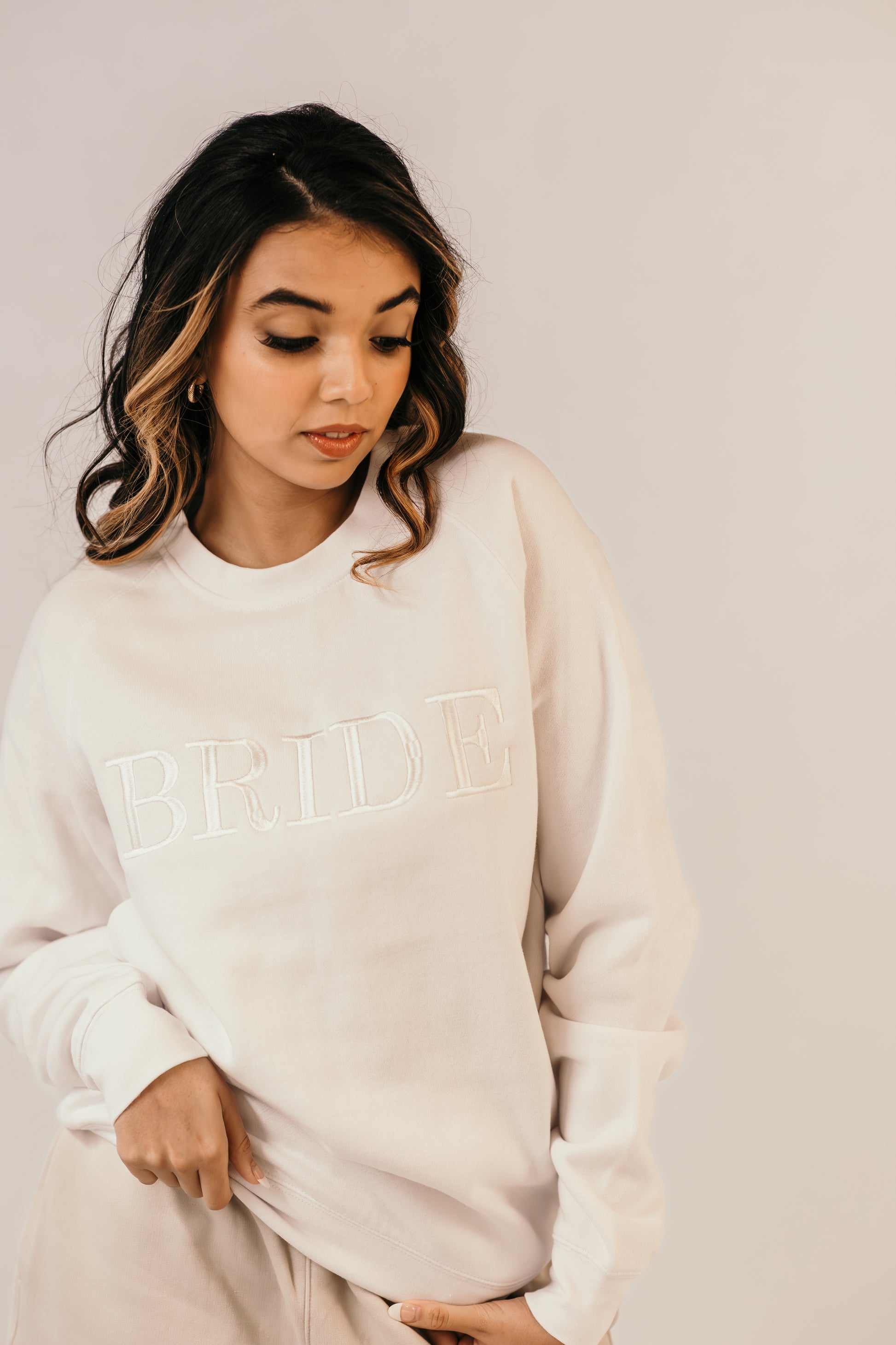 Bride wearing white crew neck sweater relaxed fit bridal outfit