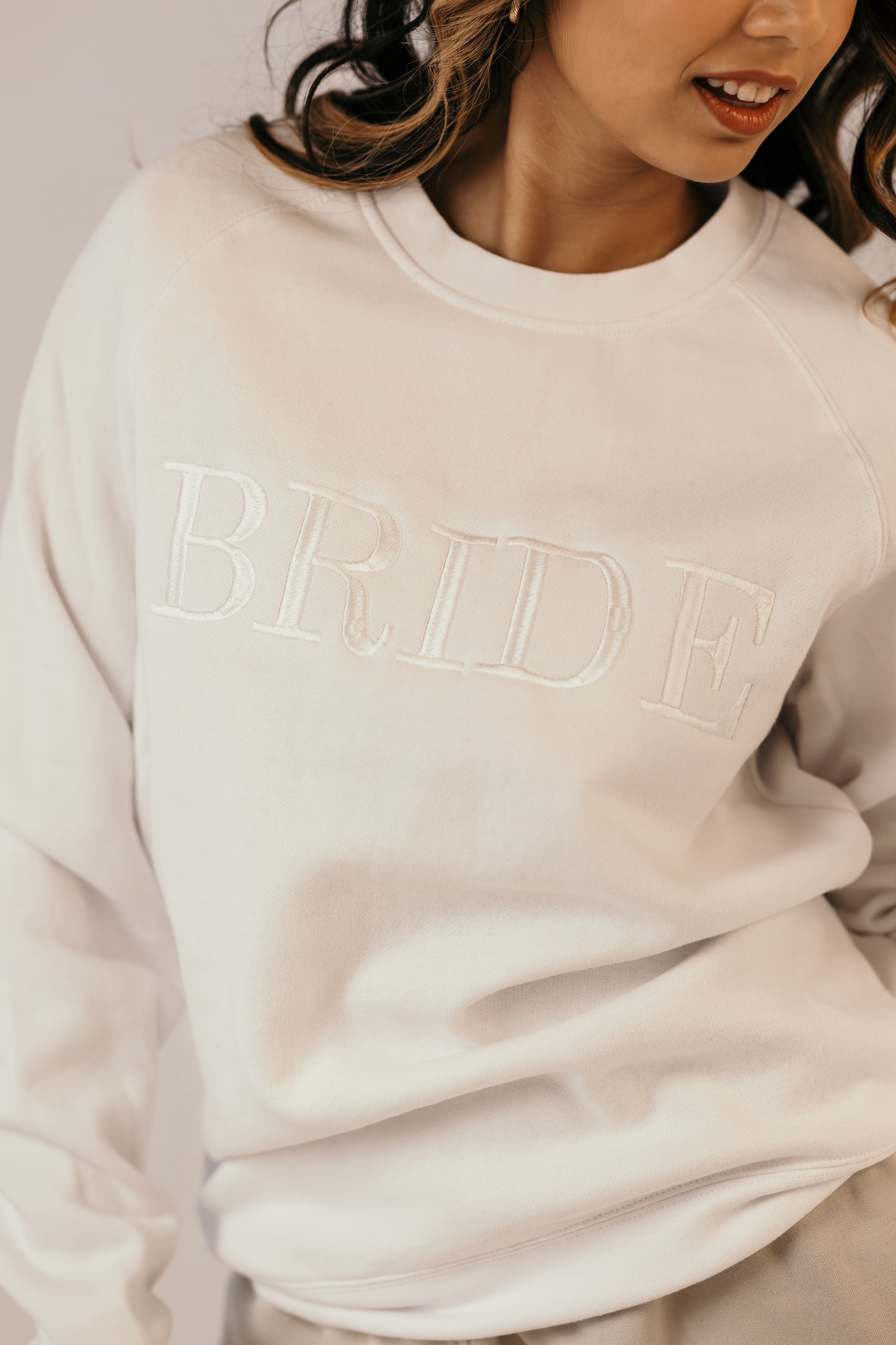 White bridal crew sweater close up tonal embroidery detail