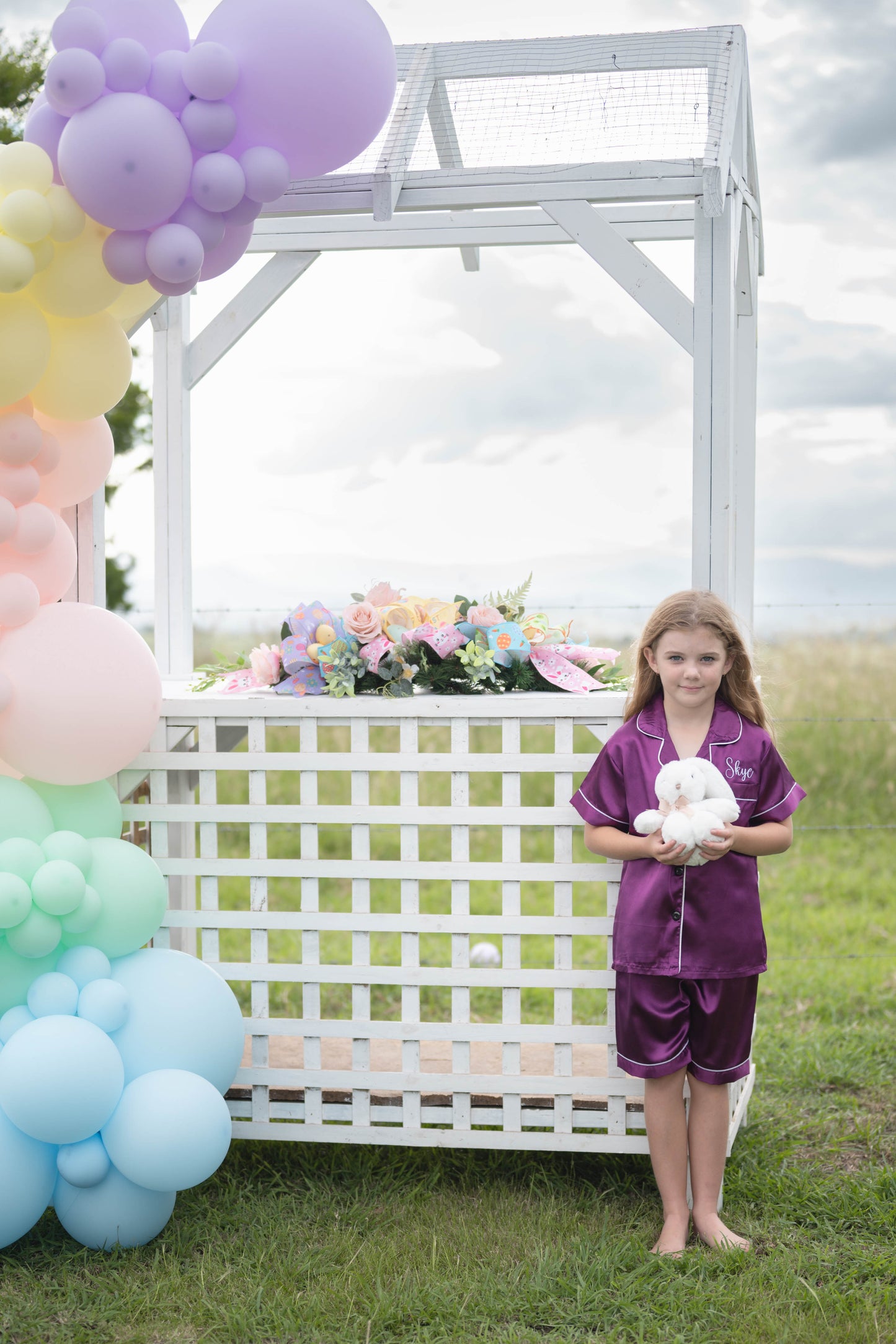 Child in Luna Kids purple satin pyjamas standing outdoors