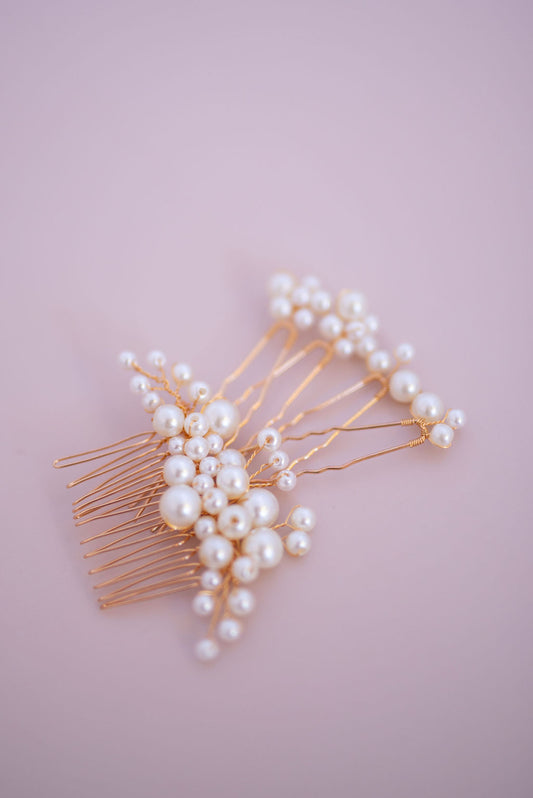 Pearl bridal hair comb set with delicate clustered pearls on soft lilac background
