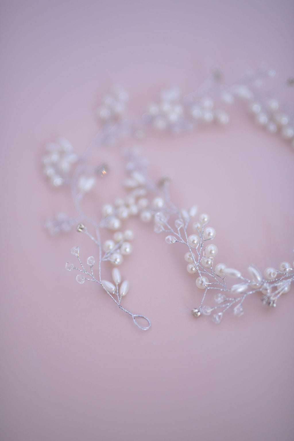 Flexible silver bridal hair vine arranged to show elegant shape and detailing.