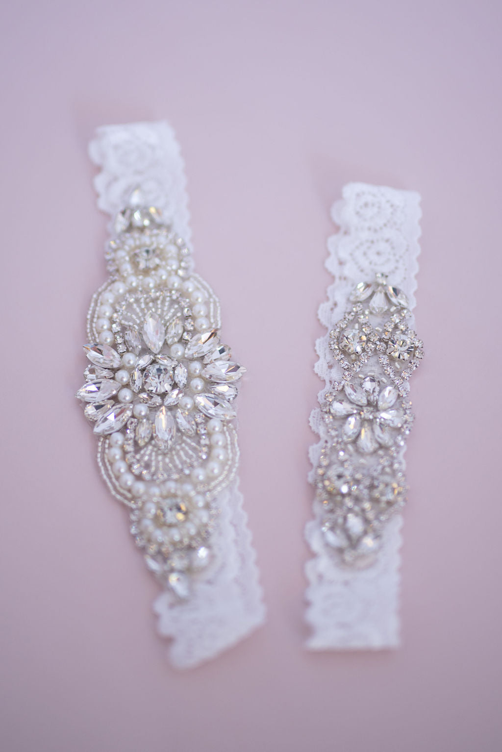 Complete pearl and diamante bridal garter set displayed on neutral background.