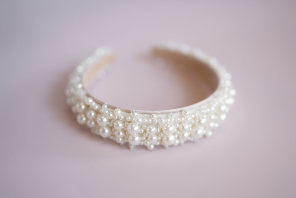 Side view of pearl bridal headband showing layered pearl detailing and curved shape