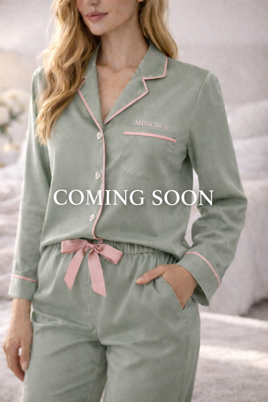 Woman wearing sage green TENCEL™ luxury pyjama set with blush pink piping and MISSOSCA® logo, Coming Soon overlay