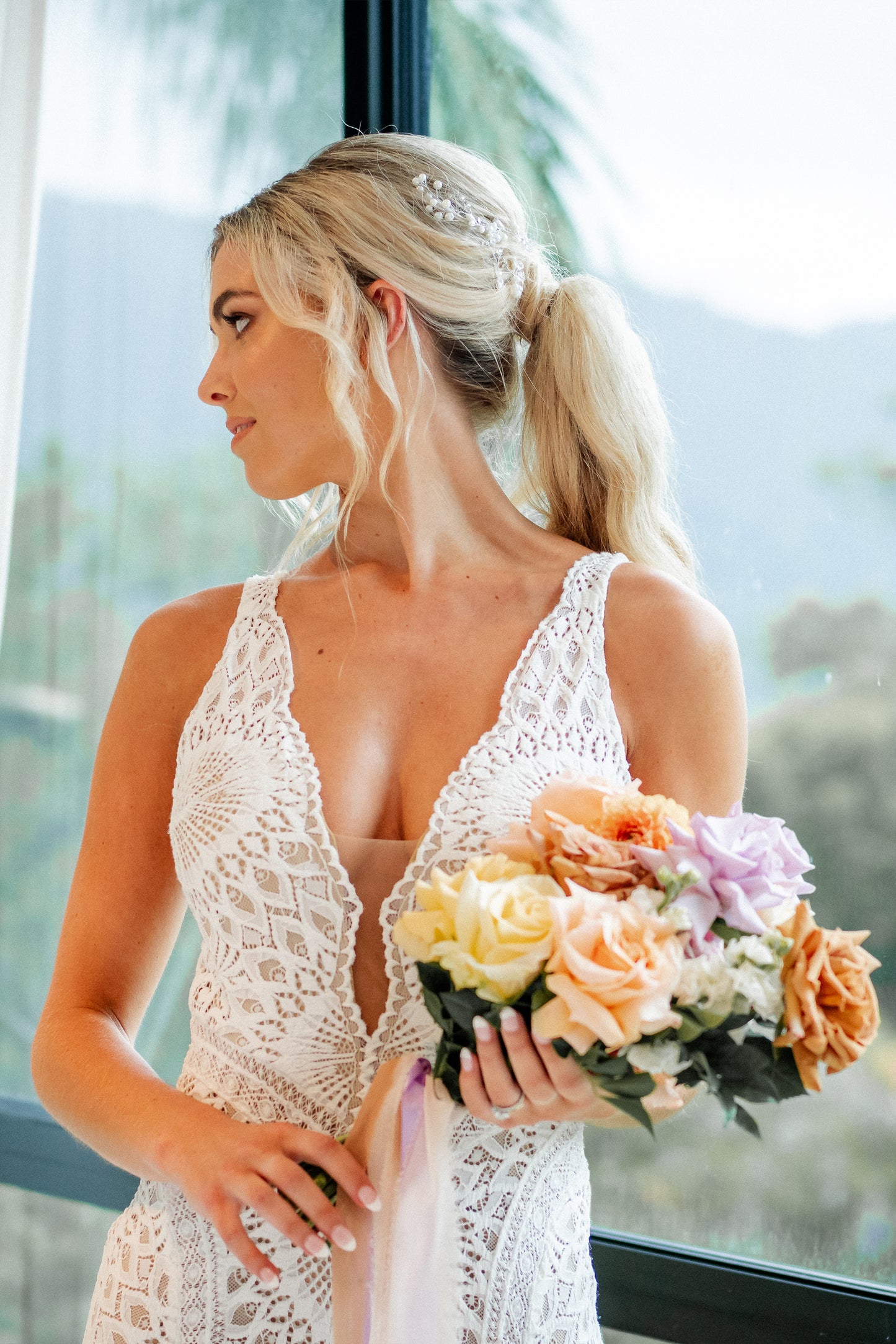 Bride wearing silver hair vine accessory with soft romantic wedding styling.