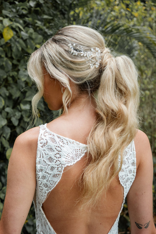 Silver bridal hair vine styled in blonde bridal updo, elegant wedding hairstyle accessory.