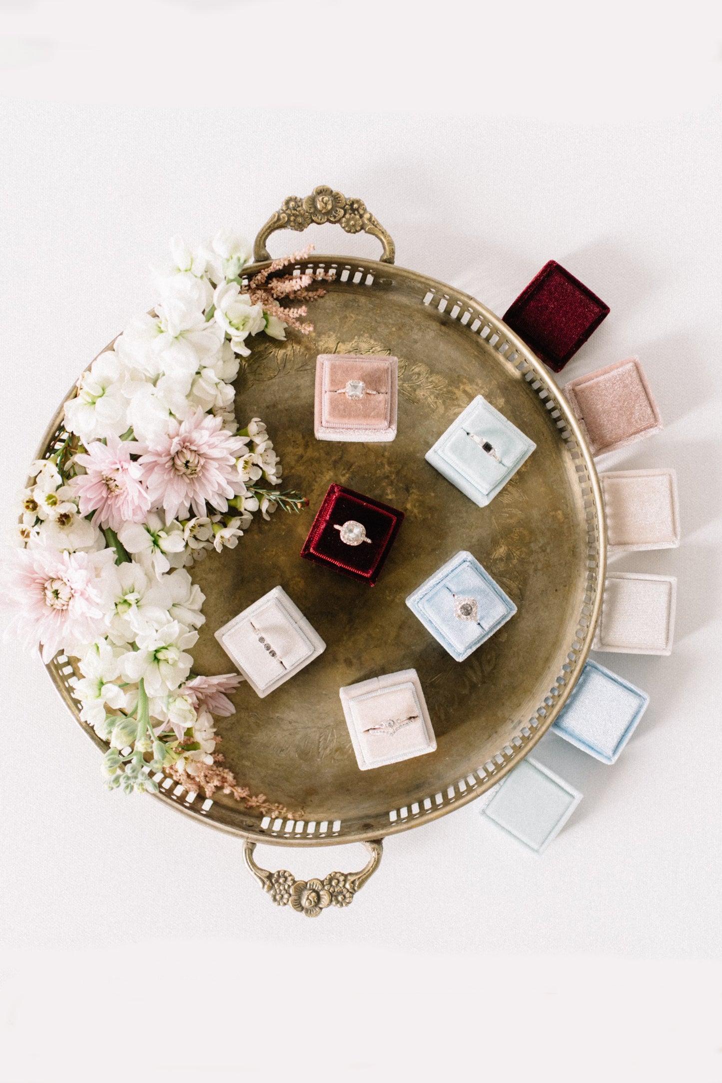 Luxury square velvet ring boxes displayed in multiple colours, elegant wedding and proposal ring presentation boxes.