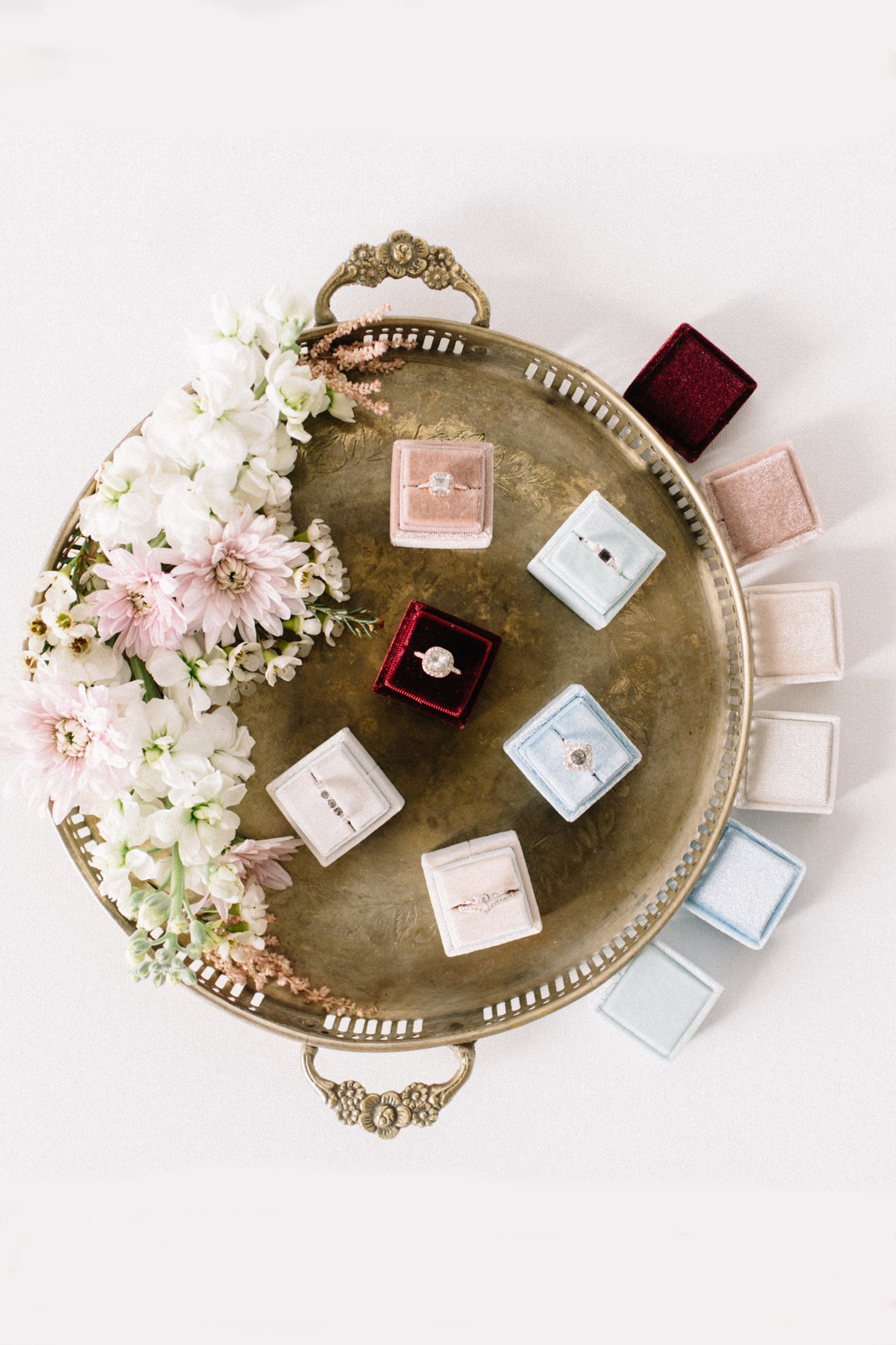 Luxury square velvet ring boxes displayed in multiple colours, elegant wedding and proposal ring presentation boxes.