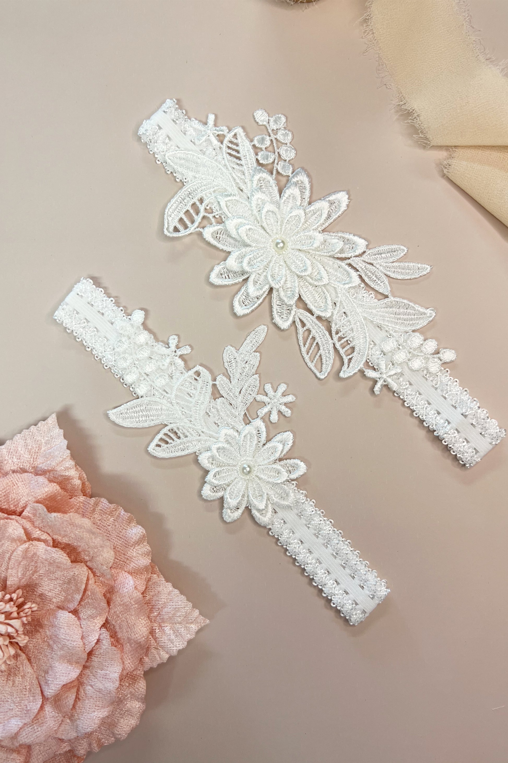 Close-up of floral lace bridal garter set showing delicate detailing and soft stretch design.