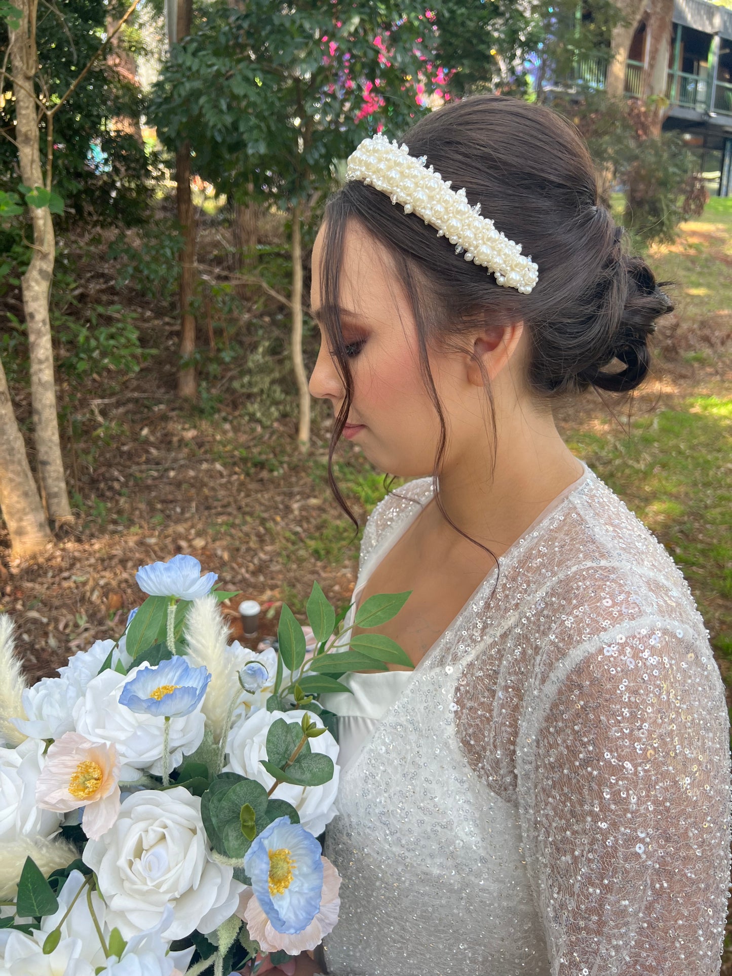 Bride wearing pearl headband styled with soft waves for romantic wedding look