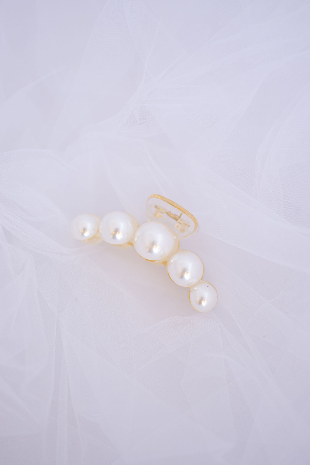 Small pearl hair clip with delicate faux pearls for subtle bridal and formal styling.