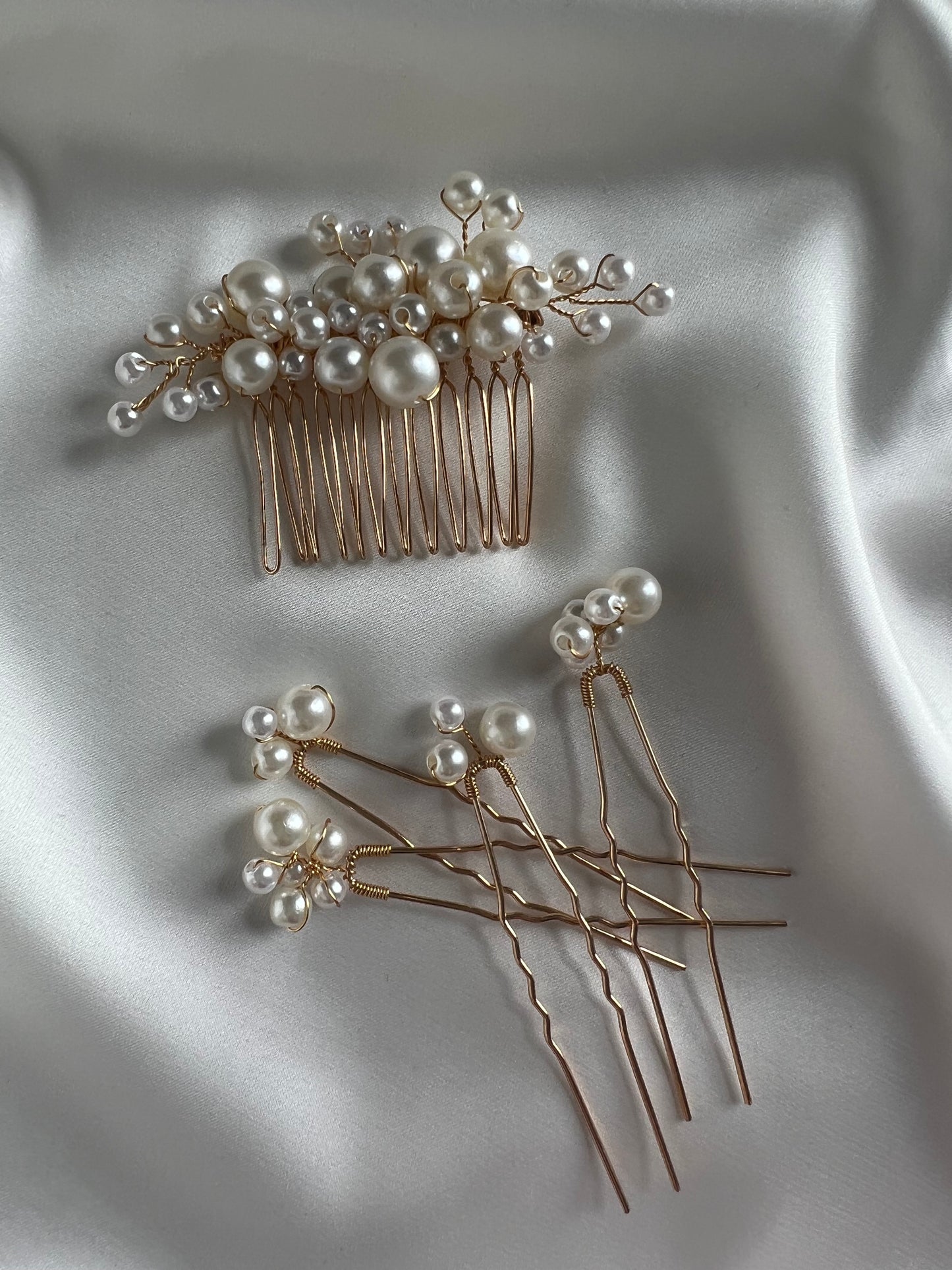 Pearl bridal comb photographed on satin fabric for elegant product styling