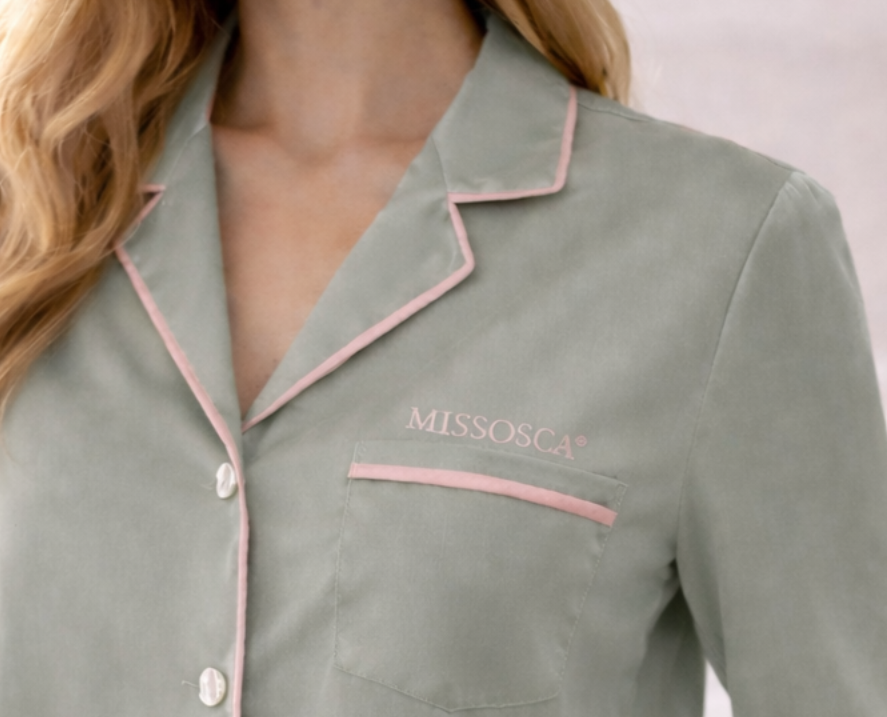 Close-up of MISSOSCA® embroidered logo on sage green TENCEL™ pyjama shirt pocket