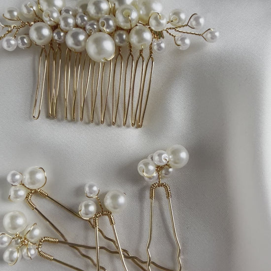 Pearl bridal comb photographed on satin fabric for elegant product styling