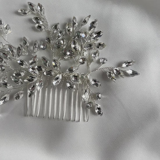 Detailed view of crystal embellishments on elegant bridal hair comb.