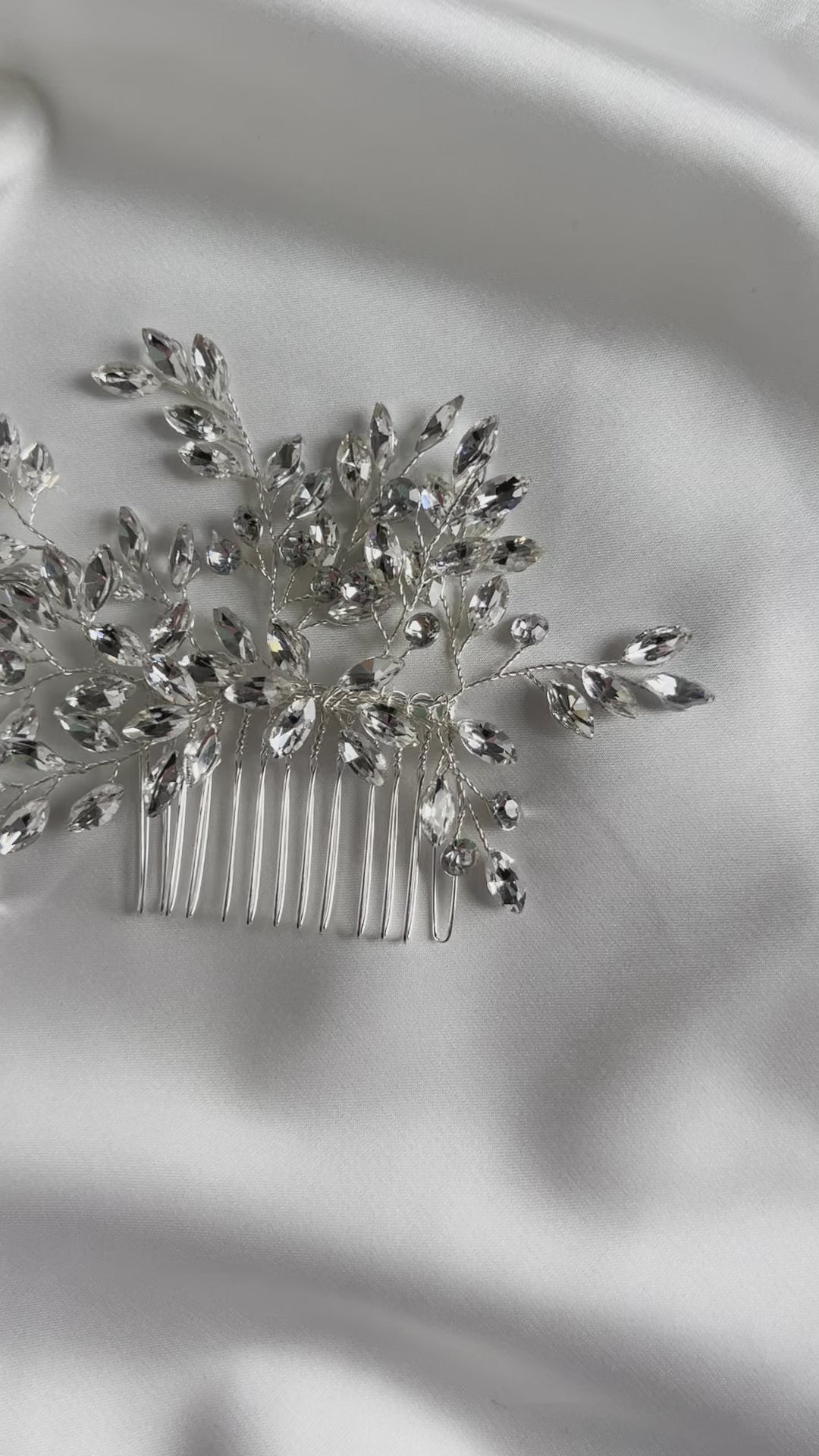 Detailed view of crystal embellishments on elegant bridal hair comb.