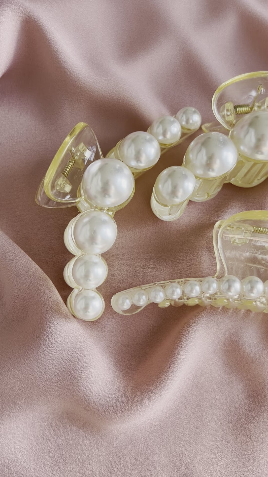 Elegant pearl hair clips styled in hair for bridal and formal occasion hairstyles.