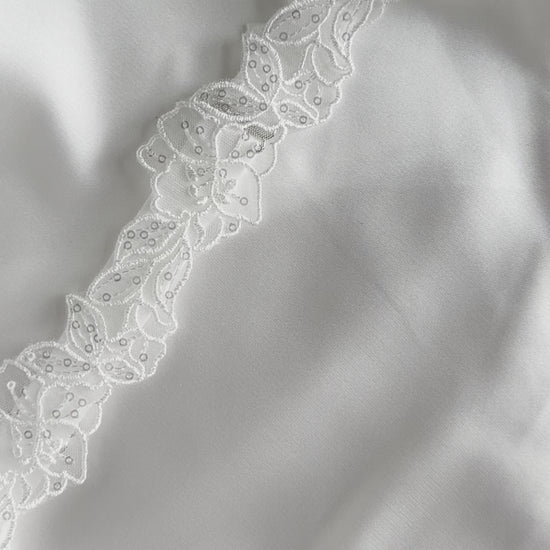 Romantic bridal garter accessory styled for wedding morning preparation.