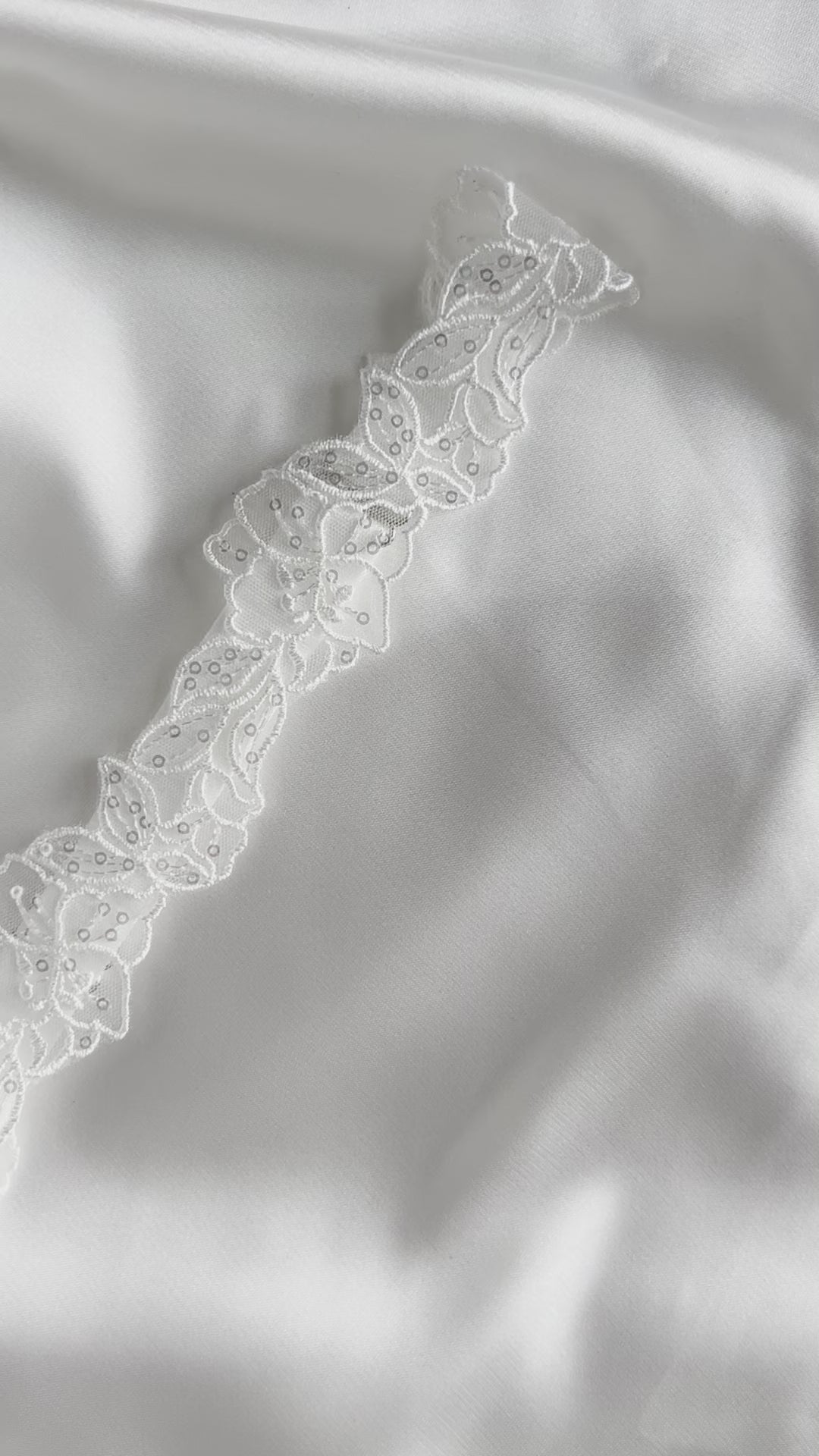 Romantic bridal garter accessory styled for wedding morning preparation.