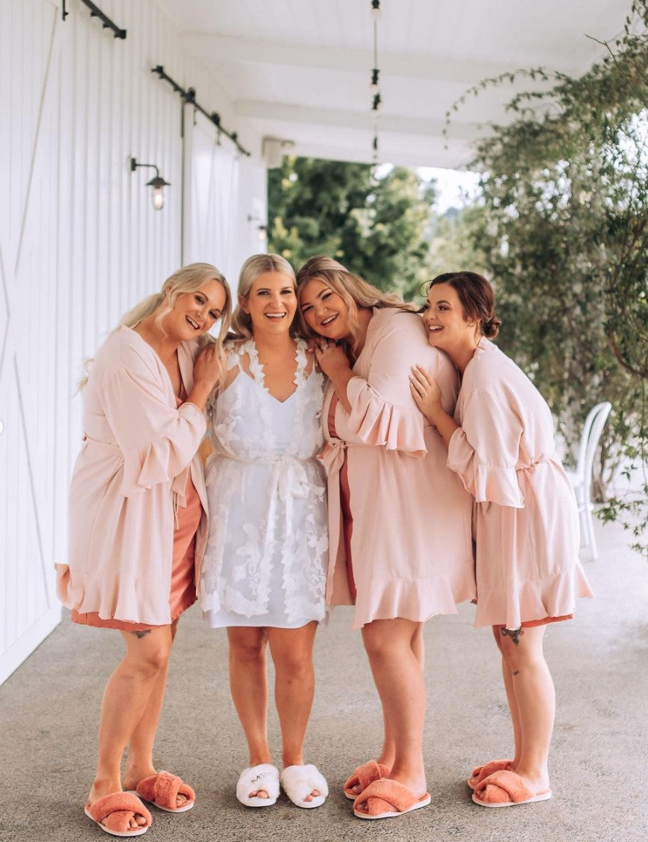 Brides wearing Charlotte chiffon bridal robe during wedding morning preparation