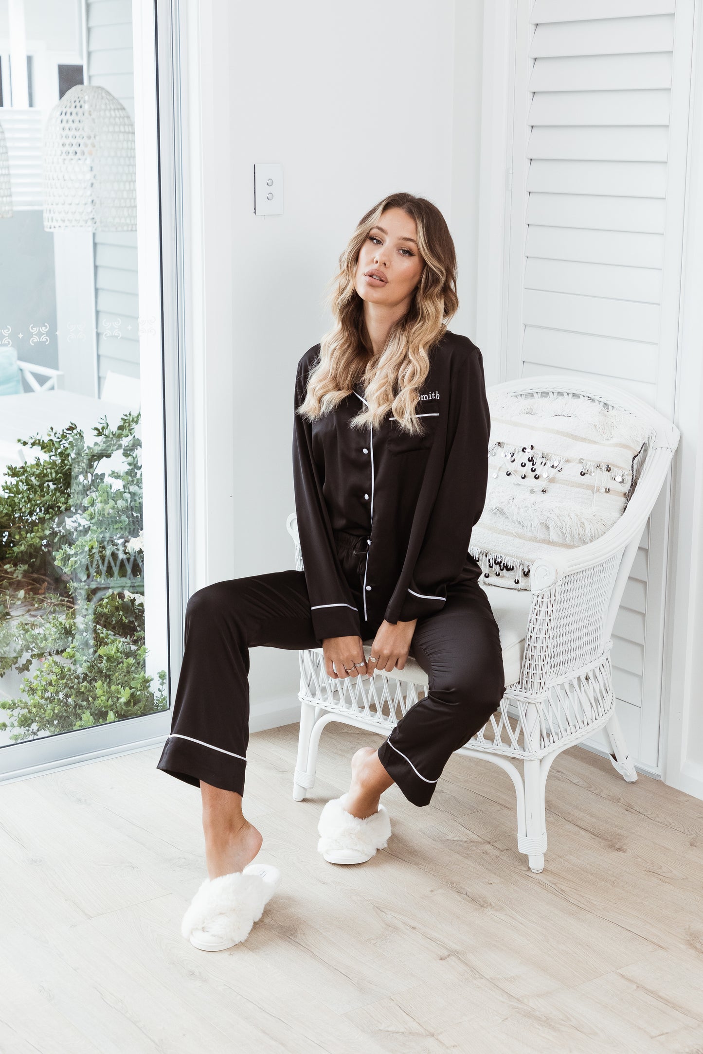 Model in black satin long sleeve pyjama set, full length sleepwear