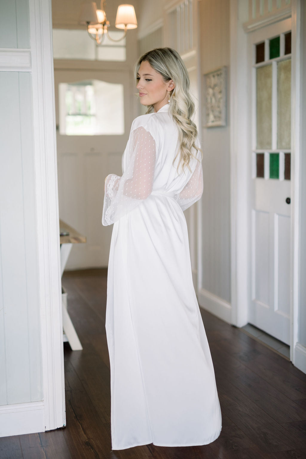 Bride wearing Ava satin lace bridal robe with flowing full length silhouette